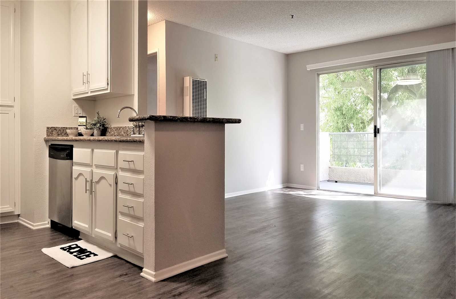 Paramount Terrace bright living room with sliding glass patio door