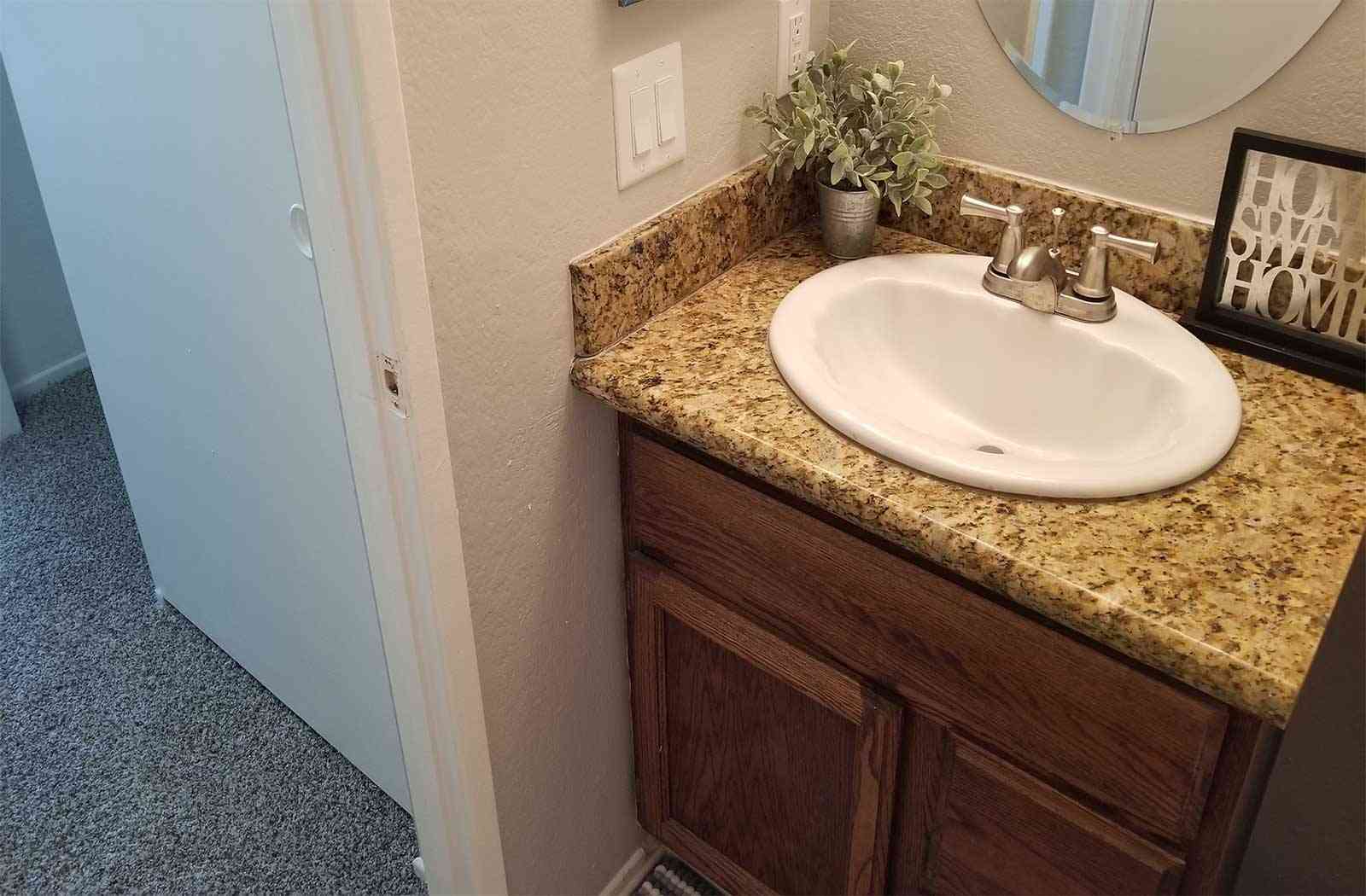 granite style counter vanity and sink