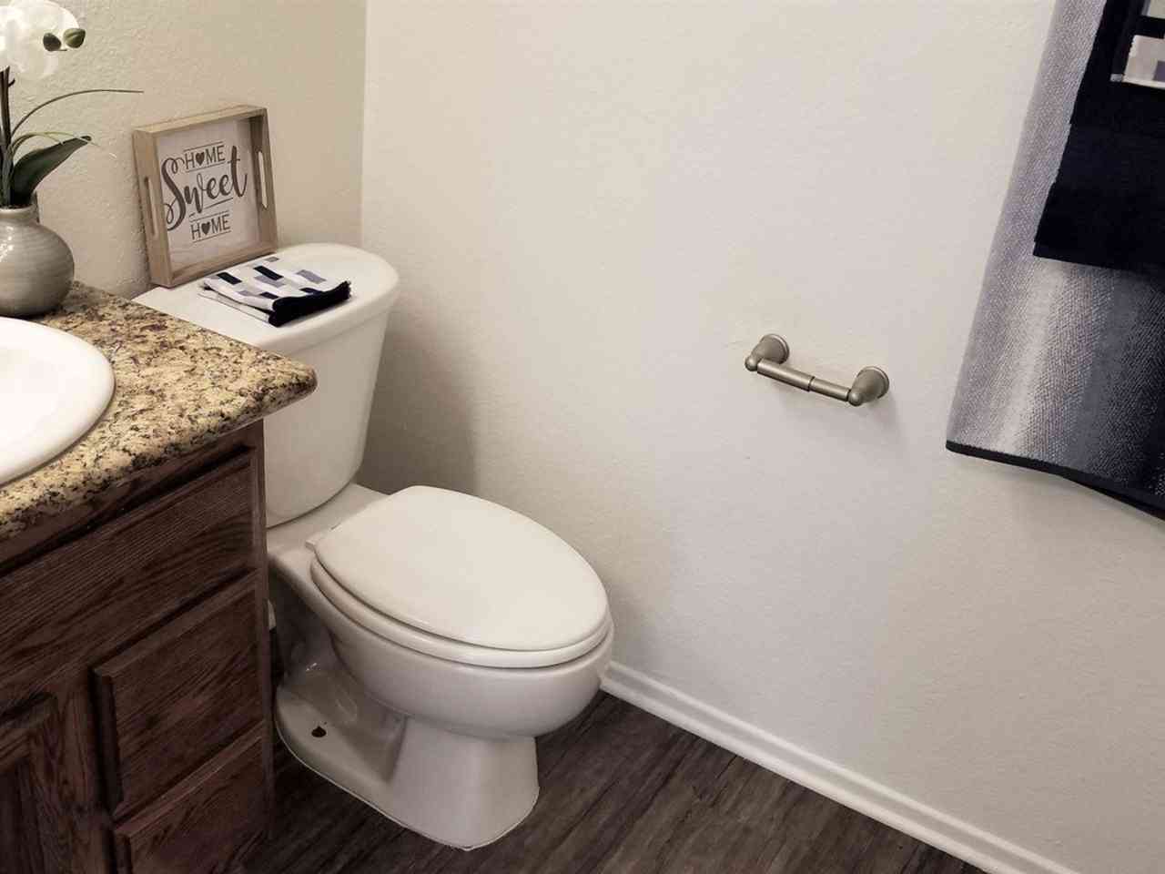 updated bathroom with wood style flooring