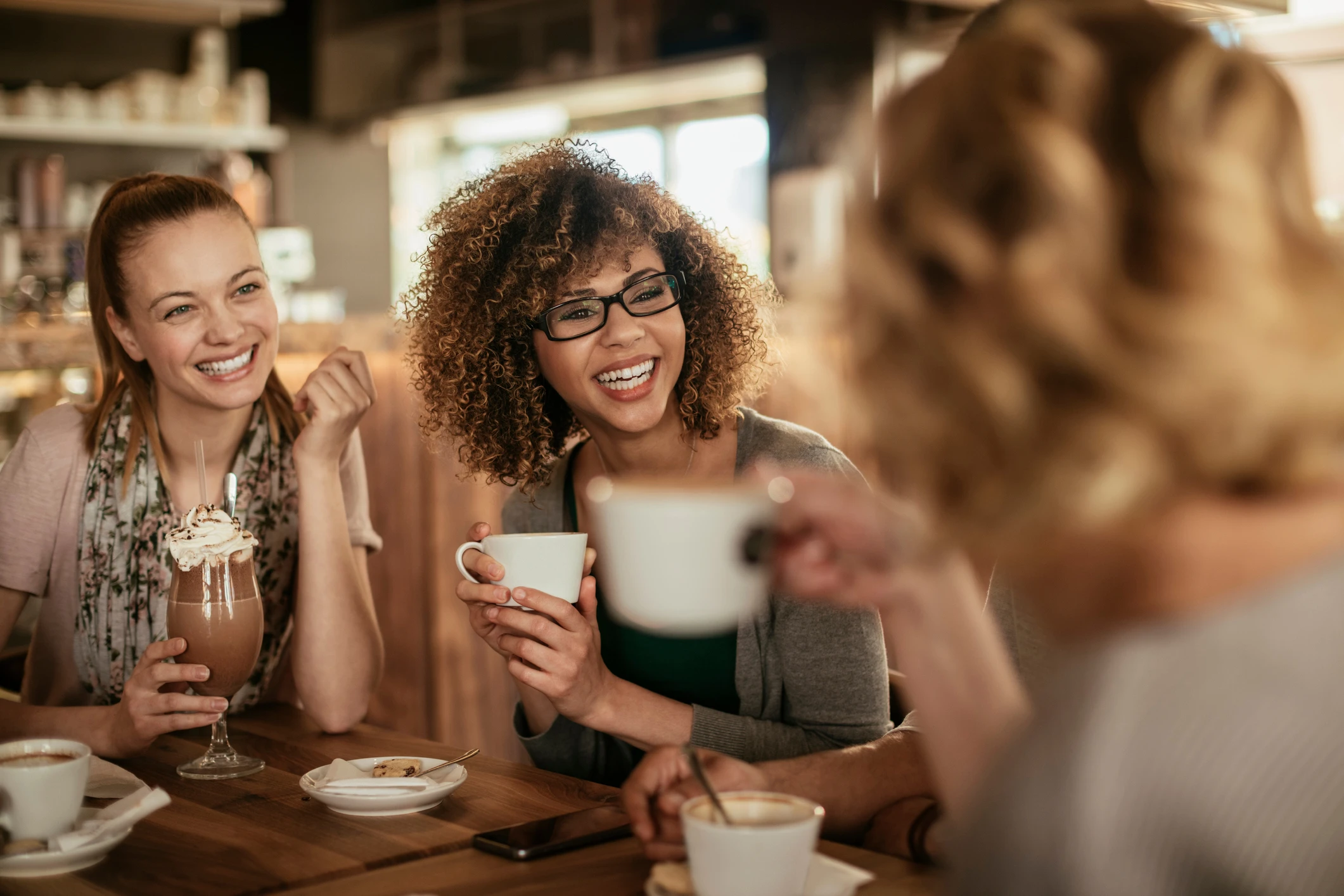 woman at cafe laughing